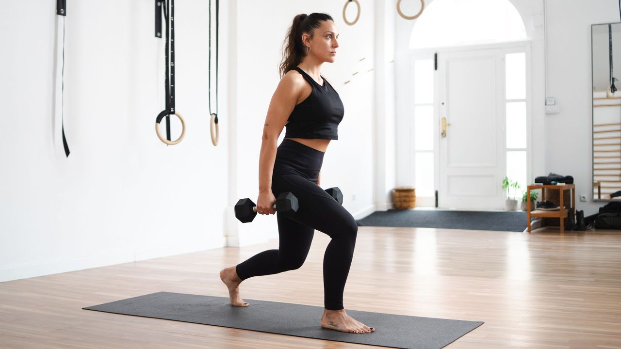 A woman trying dumbbell exercises for beginners at home