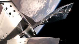 the curvature of Earth can be seen behind a silver spaceplane
