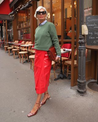 woman in grey top and bright red skirt
