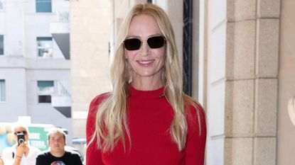 Uma Thurman headshot wearing red mock neck top