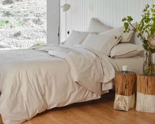 Percale Sheet Set from Riley in white on bed with big window behind and two wooden side tables