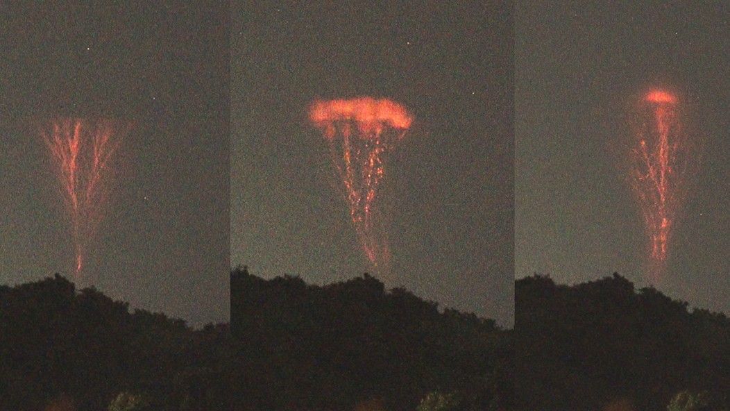 red bolts of lightning above a large storm cloud