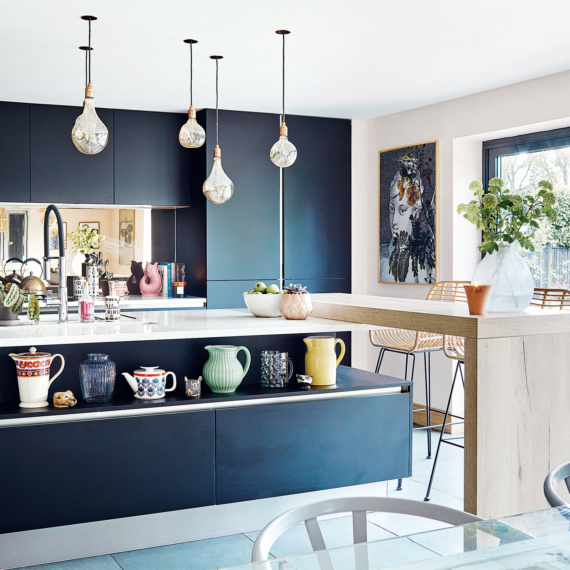 Navy blue kitchen with wooden island extension