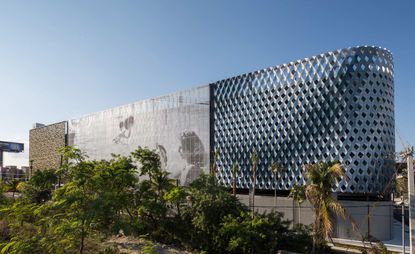 Daytime outside image of The City View Garage, trees and shrubs, metal frame exterior, blue sky