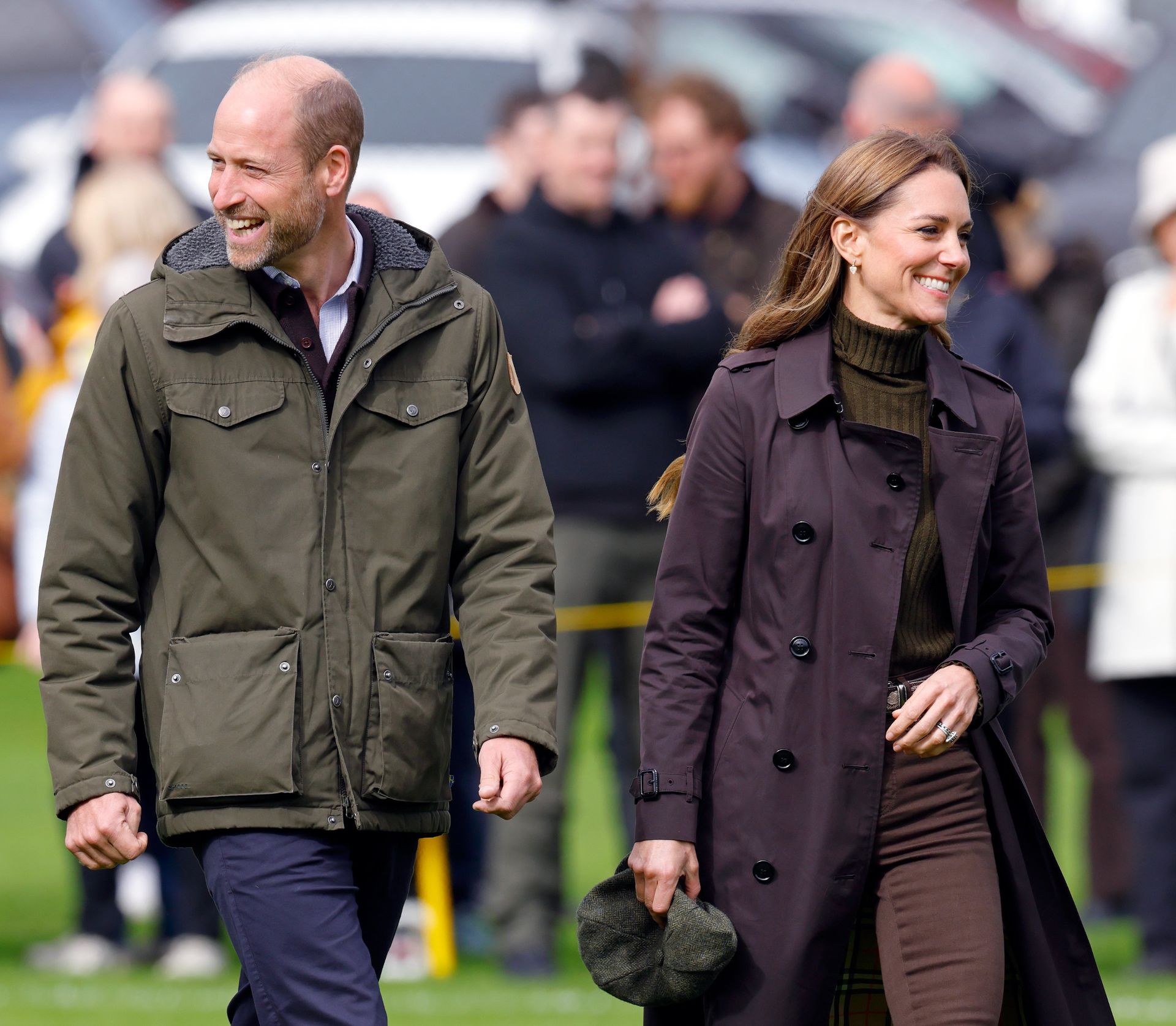 Prince William and Princess Kate walking next to each other and smiling