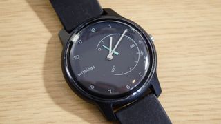 The Withings Move smartwatch pictured on a wooden surface