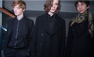 3 male models in studio wearing dark clothing