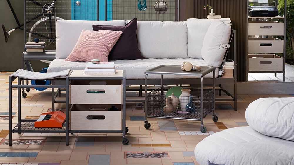 tiles flooring with books on table and sofa with cushions