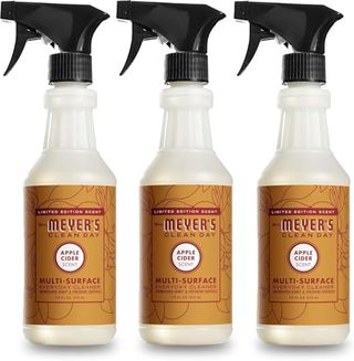 Three white plastic spray bottles with black spray lids, orange/brown labels 