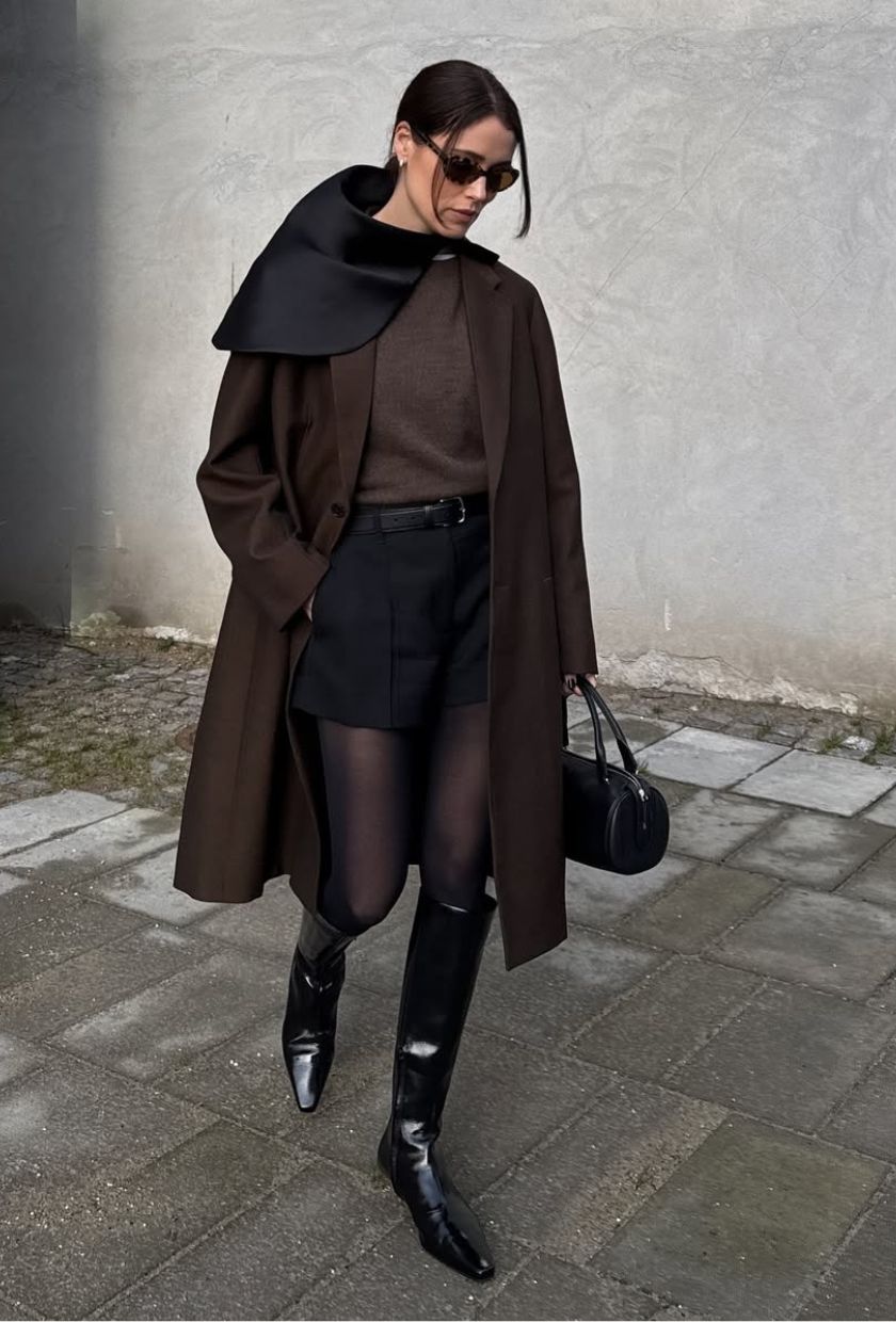 @annabelrosendahl wears a brown wool coat, jumper, black shorts, kitten-heel boots and a barrel bag