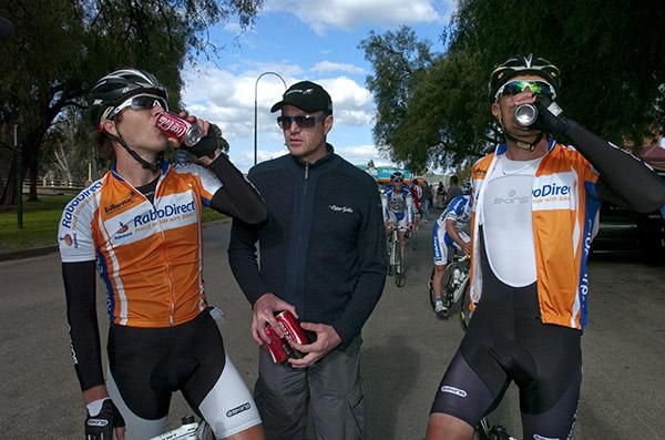 Coke adds life: Rabodirect New Zealand team-manager John Dam (centre) supplies the coca-cola for stage winner Aaron Gate (left) and Peter Latham.