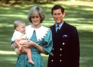 Prince Charles and Princess Diana pose with their baby son, Prince William, in the gardens of Government House