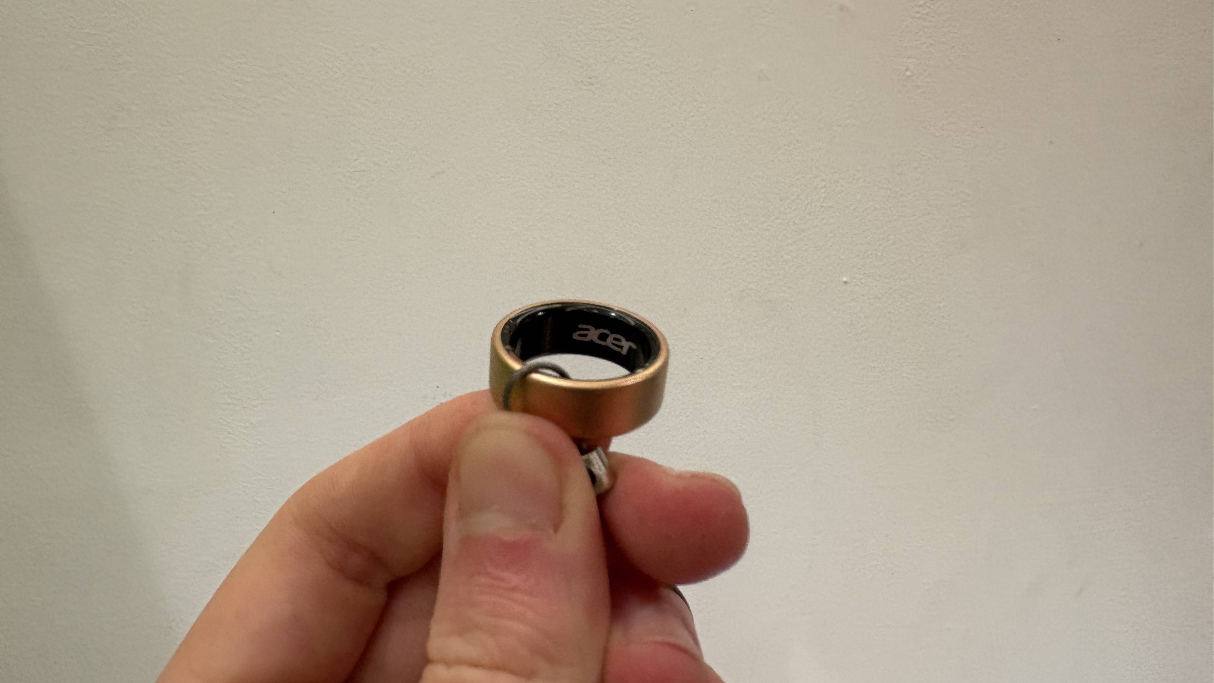 Acer FreeSense Ring in Rose Gold held with fingers