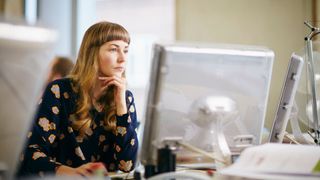 Woman looking at computer in office