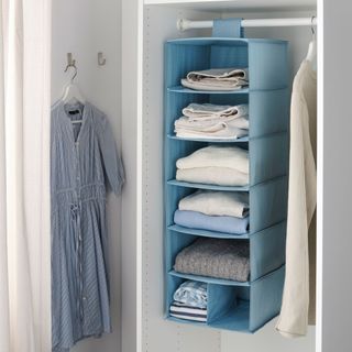 Blue hanging storage with silver wall hooks