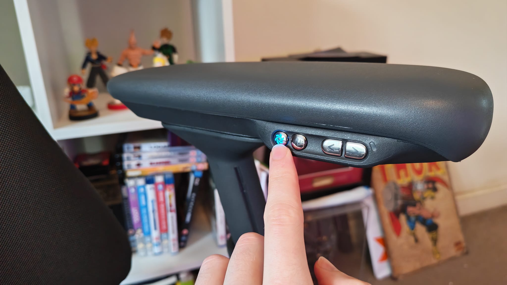 A reviewer pressing the LiberNovo Omni Pro's fan function