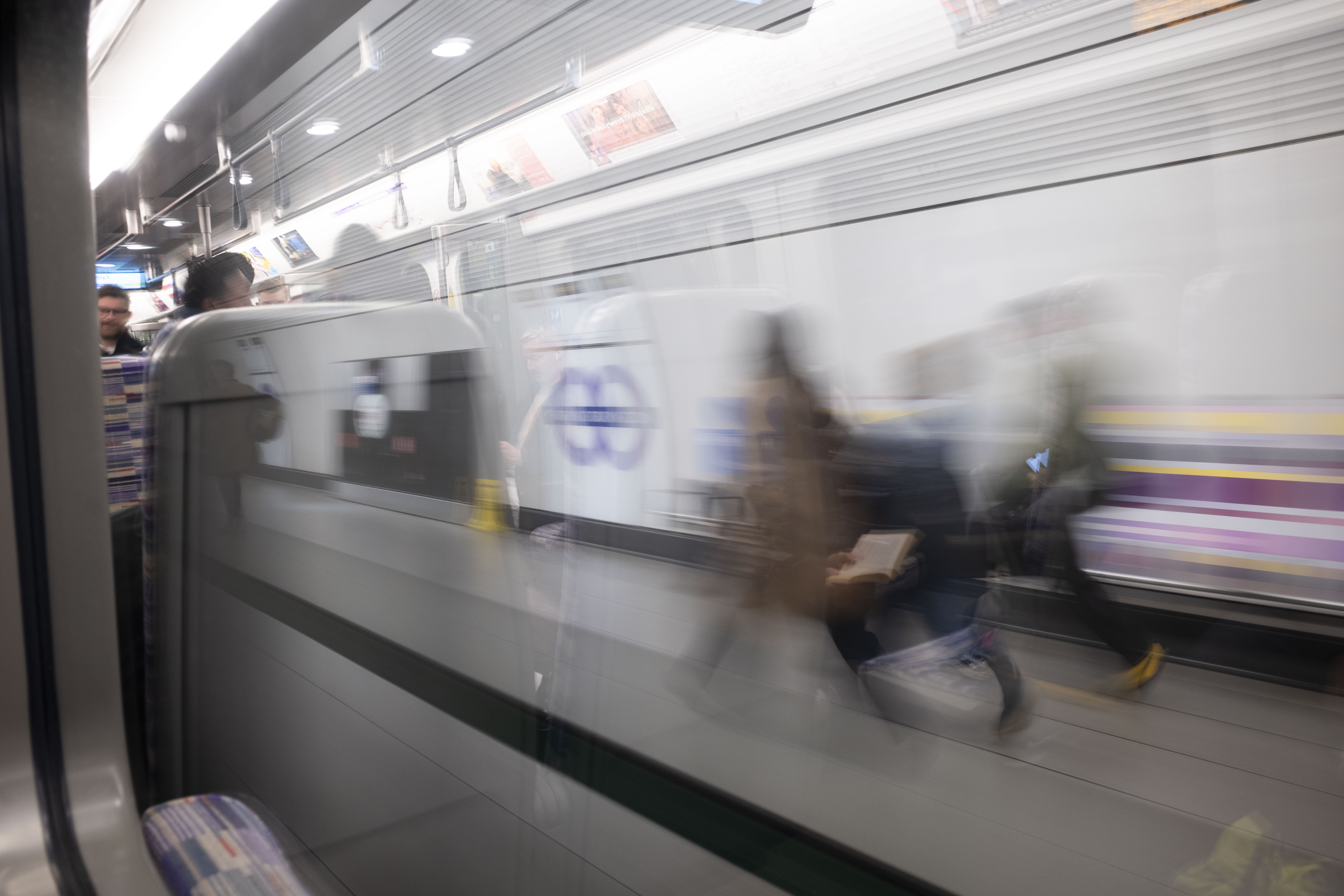 Ricoh GR IV sample images - blurry image of commuters running to catch a train