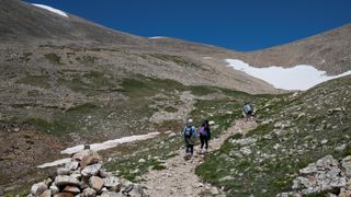 Hikers walk on the trail toward Mount Democrat near Alma