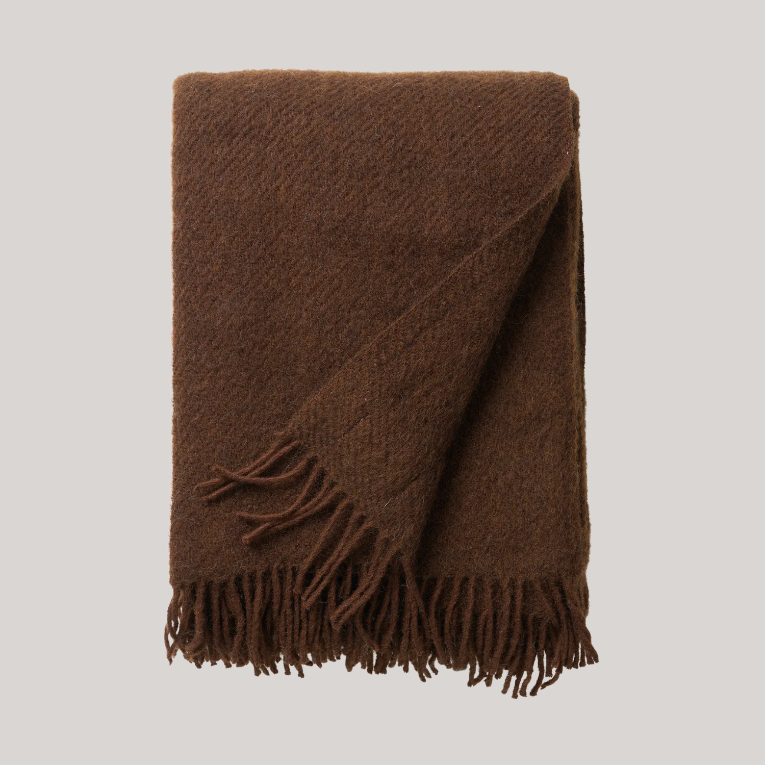 A brown throw with a fringe hem