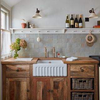 row of kitchen units in small cottage kitchen, with butlers sink and basket drawers in cabinet