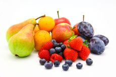 Several types of fuit, including blueberries, strawberries, pears and apples, sit against a white background. 