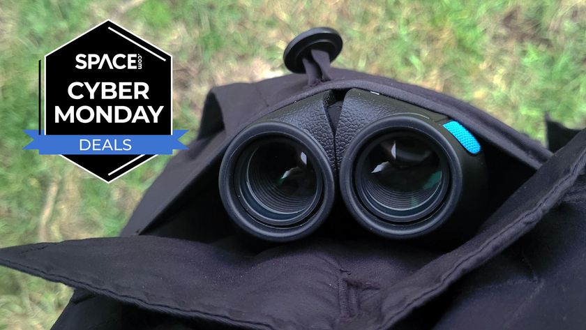 The Occer 12x25 compact binoculars in a black coat pocket with a black Space.com Cyber Monday deals badge in the upper left corner. 