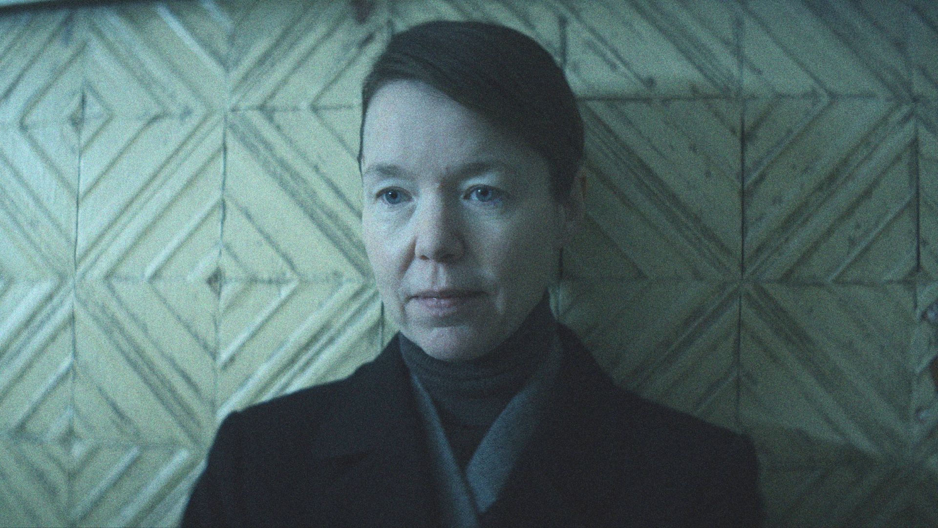 Anna Maxwell Martin leans against a wall