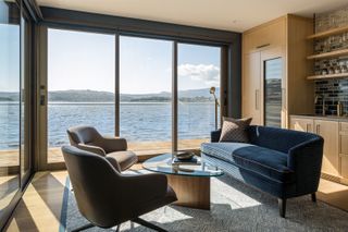 coastal living room with floor to ceiling windows