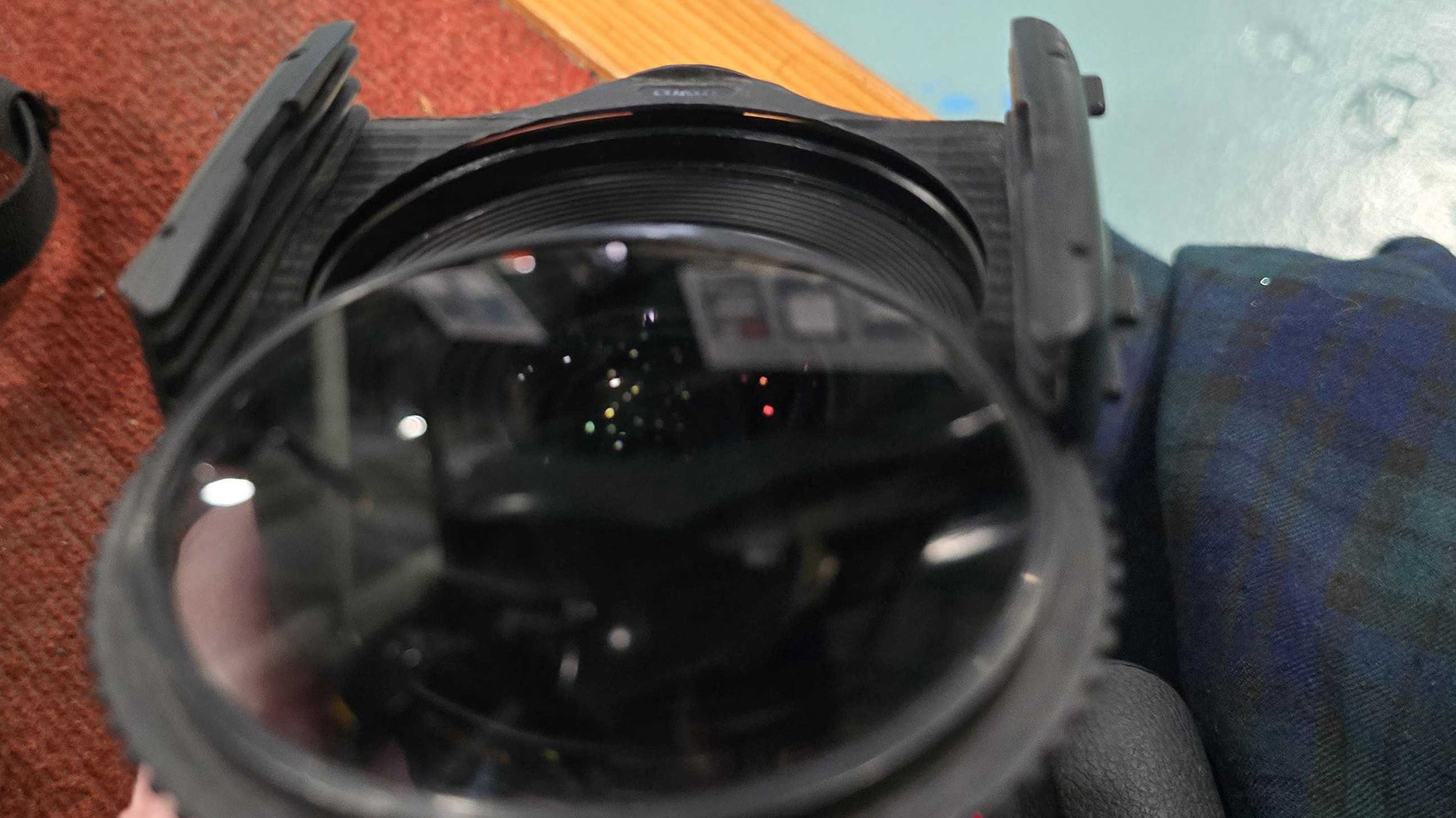 Drop in the circular polariser and rotate it to remove reflections