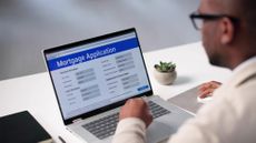 Man at his computer filling out a Mortgage Application