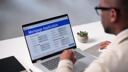 Man at his computer filling out a Mortgage Application