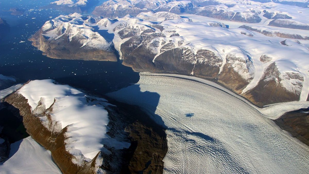 A photograph of Rink Glacier in Greenland, with a meltwater lake visible on top of the ice.