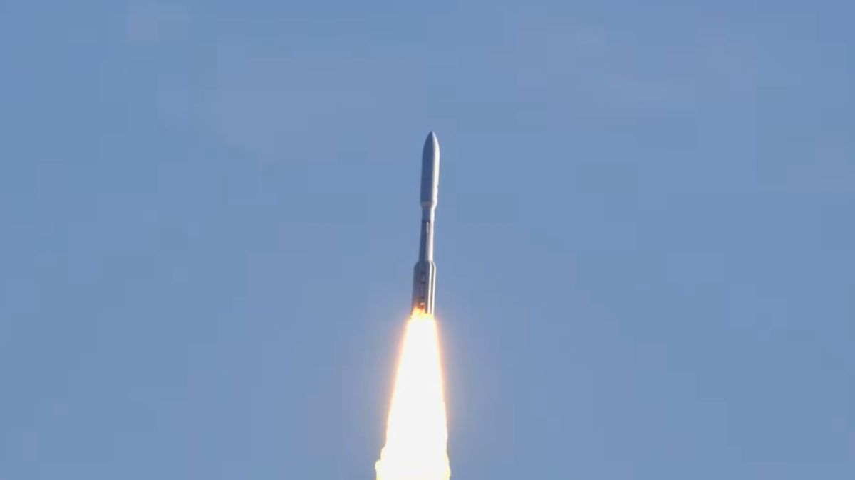 view of rocket flying through a blue sky