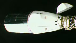 a cone-shaped spacecraft attached to a space station module