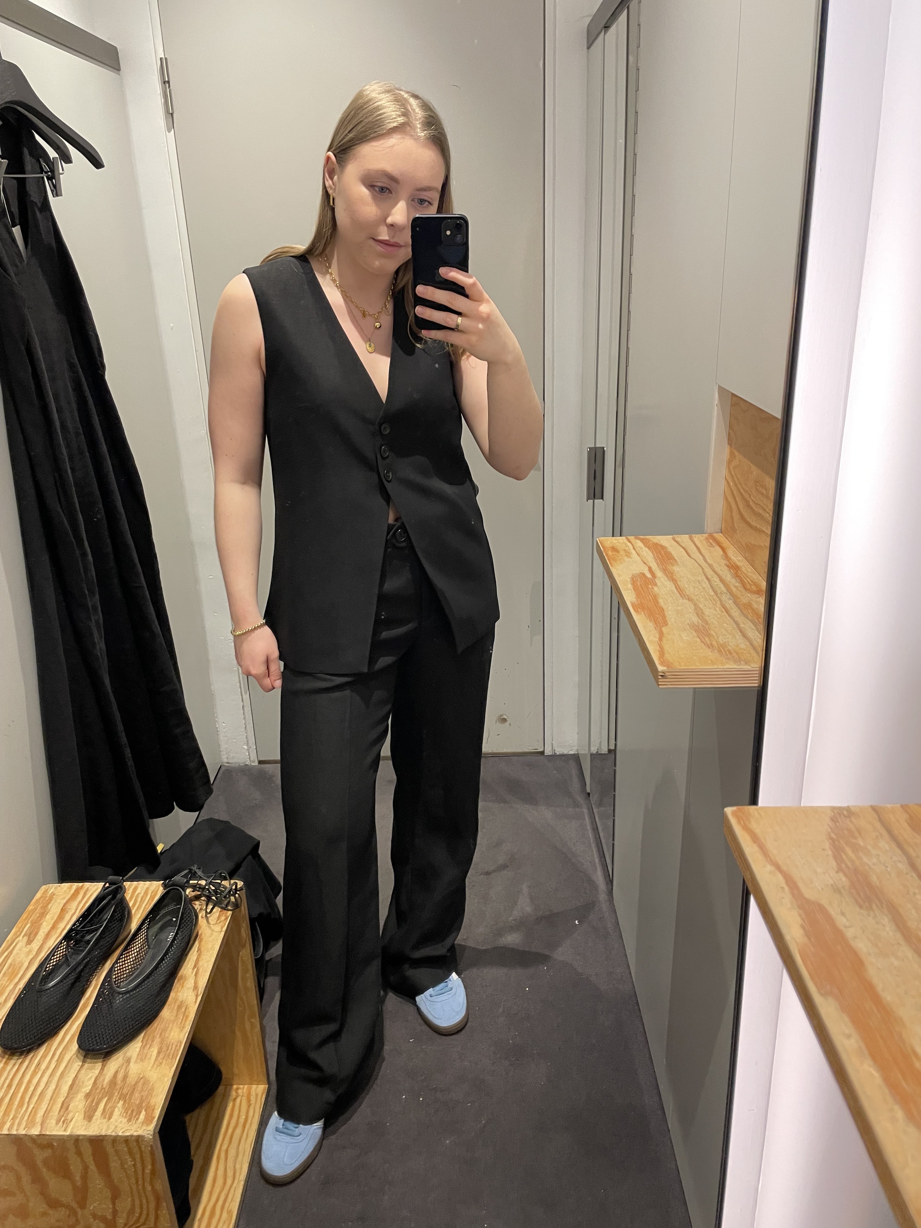 Woman in dressing room wears linen waistcoat and linen trousers