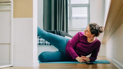 Woman exercising on the floor at home