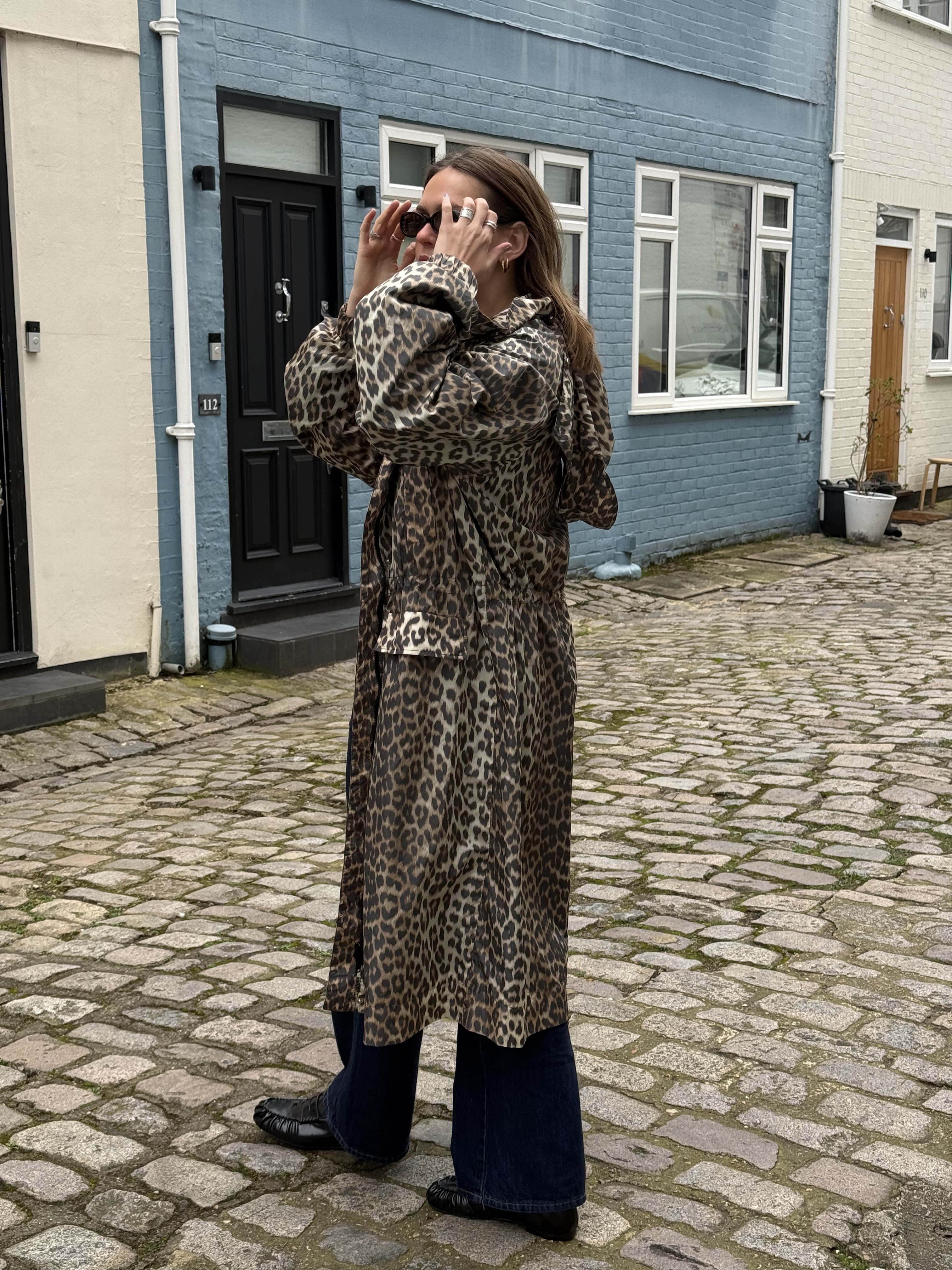 An image of Who What Wear UK assistant social media editor Annie Wheatland-Clinch wearing a Ganni raincoat .