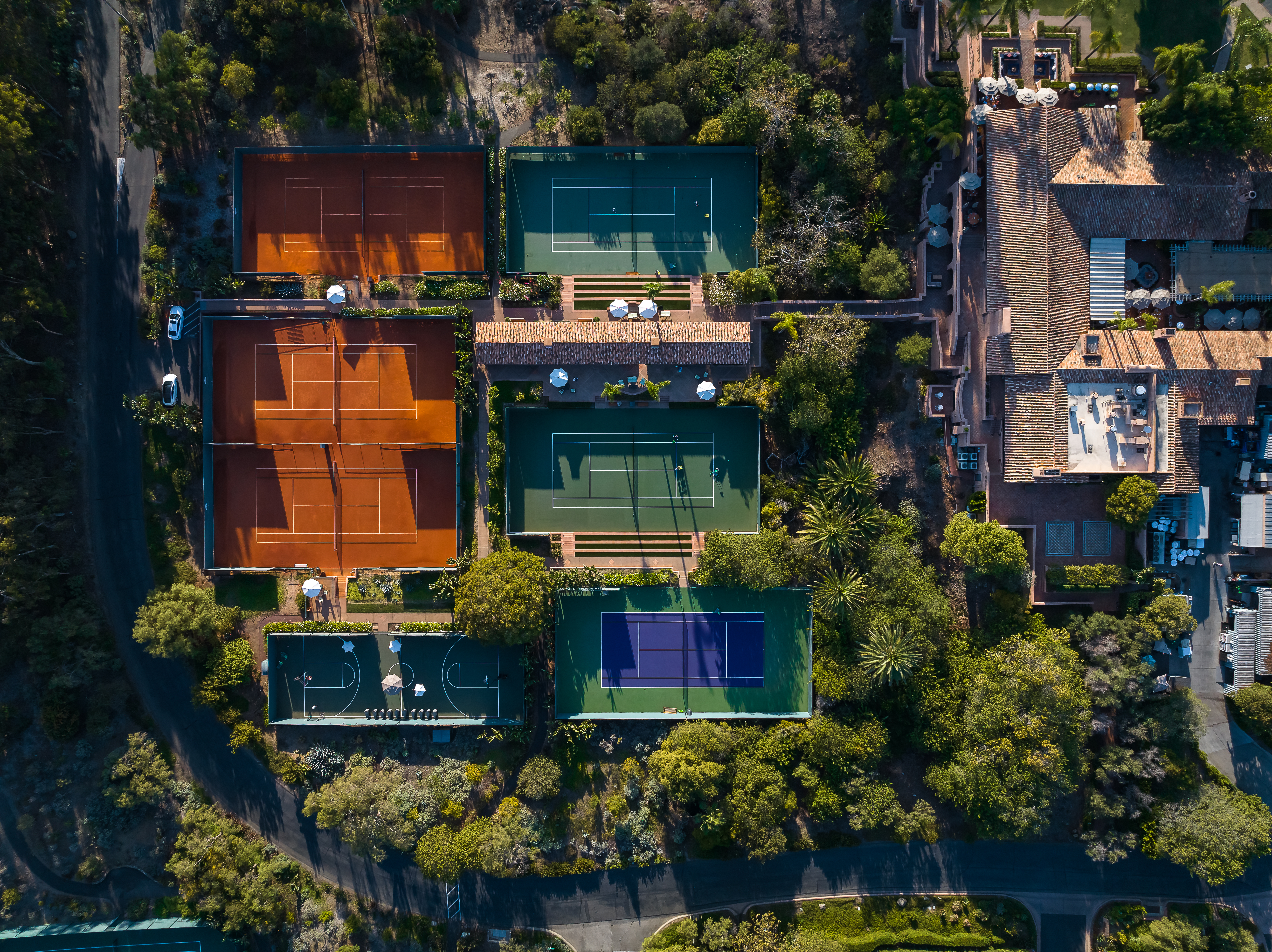 A drone shot showing the tennis facilities at Rancho Valencia Resort & Spa