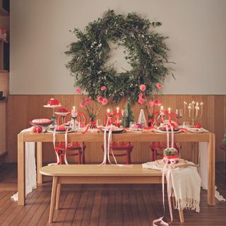 Habitat table and bench with pink and red tablescape