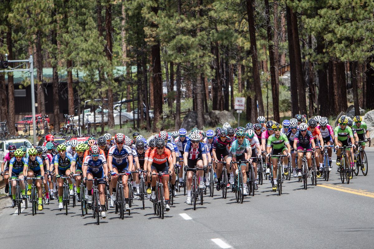 The women's field spreads across the road before taking up the chase