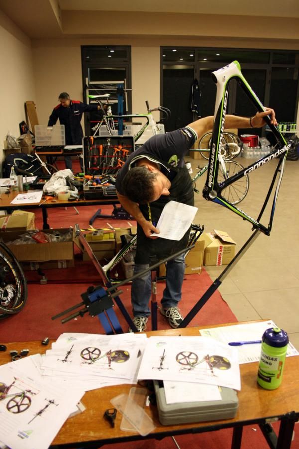 A mechanic checks the number of a new race frame