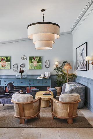 living room with big pendant light and wicker chairs