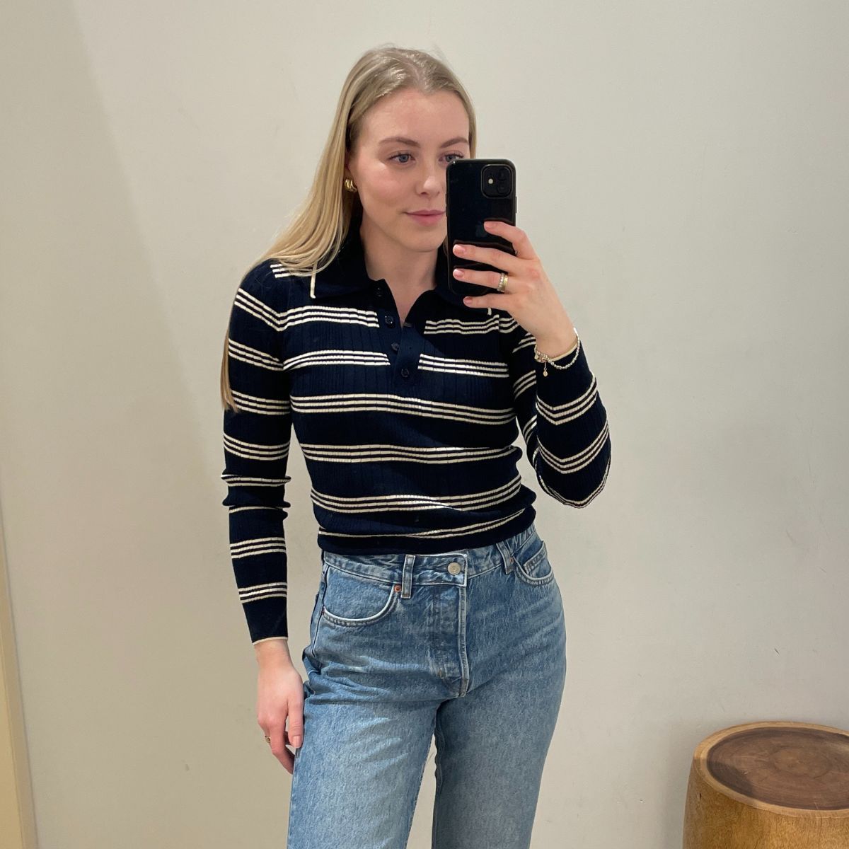 Florrie wears a navy striped sweater, blue jeans