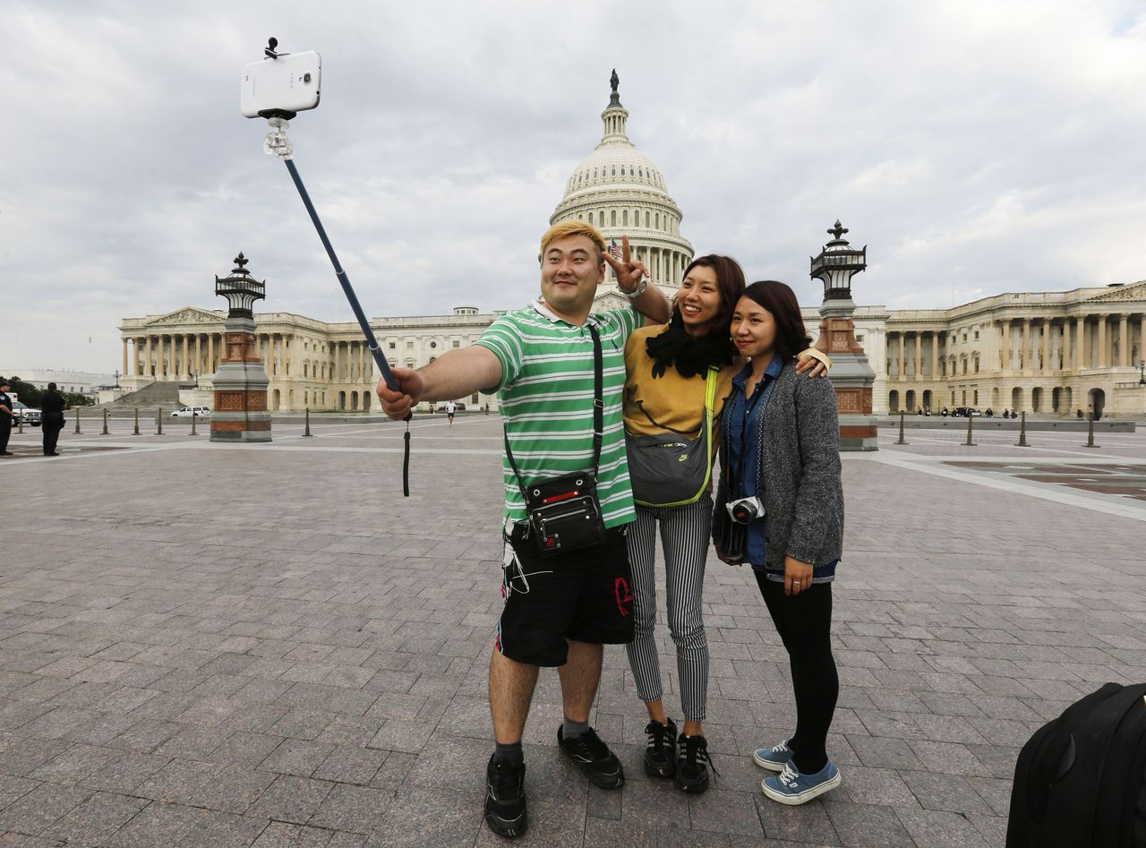 Tourists take a selfie in front of the U.S. Capital.