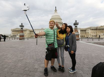Tourists take a selfie in front of the U.S. Capital.