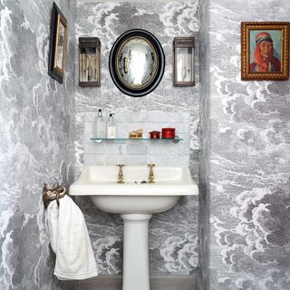 bathroom with textured wall and walled photos frames