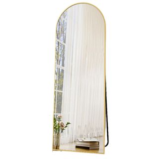 An arched gold mirror