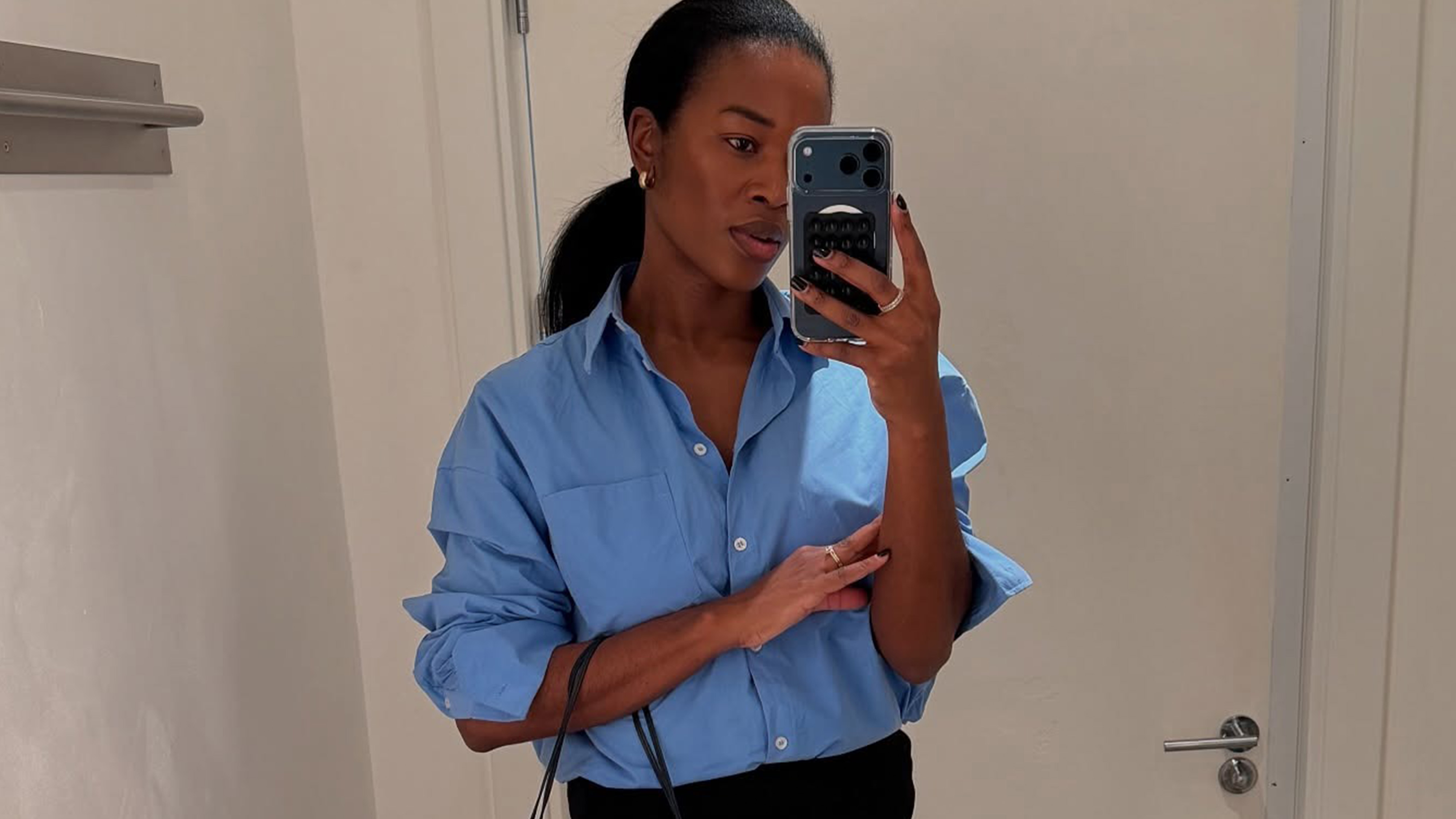 @nlmarilyn wearing a blue button-down shirt from COS.