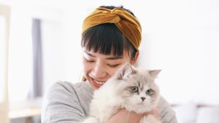 Woman cuddling cat