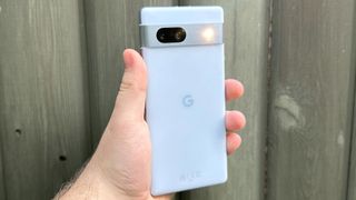 The Google Pixel 7a with its camera flash active